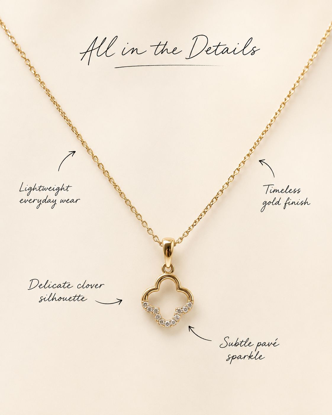 Gold necklace with clover pendant on a beige background