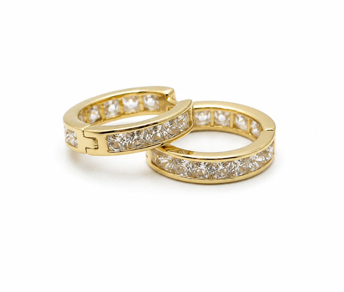 Two gold hoop earrings with diamond accents on a white background