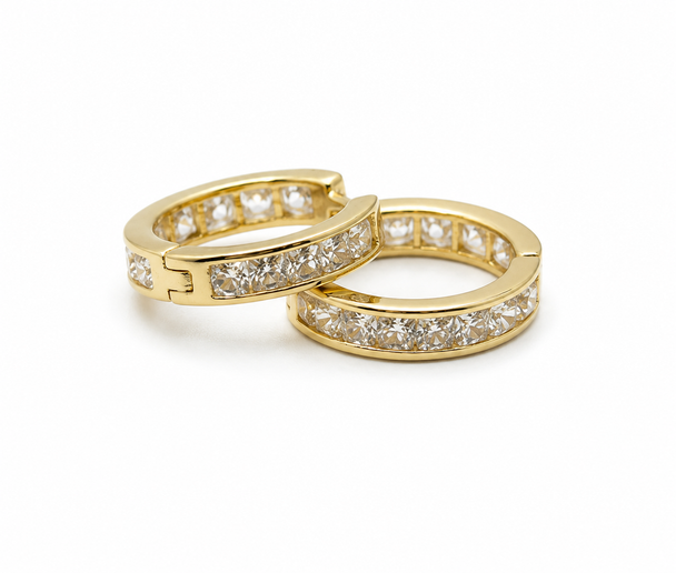 Two gold hoop earrings with diamond accents on a white background