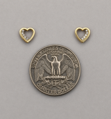 Silver quarter dollar coin with two gold heart-shaped pendants on a gray background