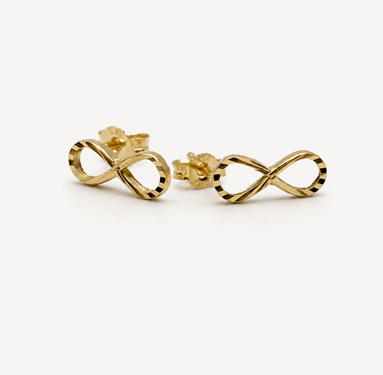 Gold infinity symbol earrings on a white background