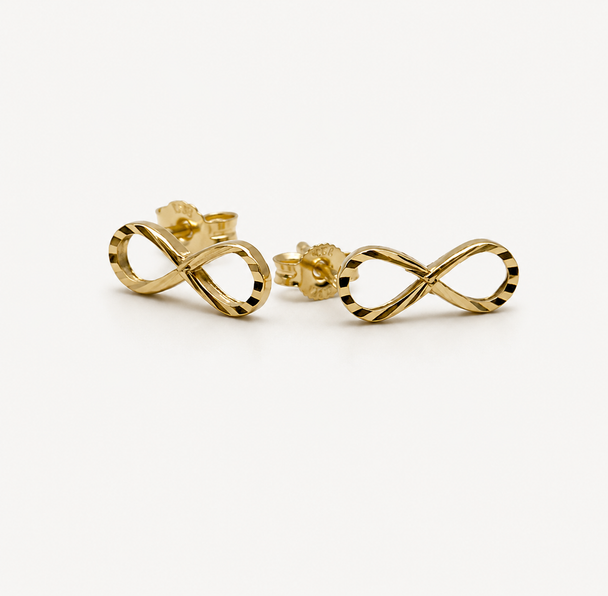 Gold infinity symbol earrings on a white background