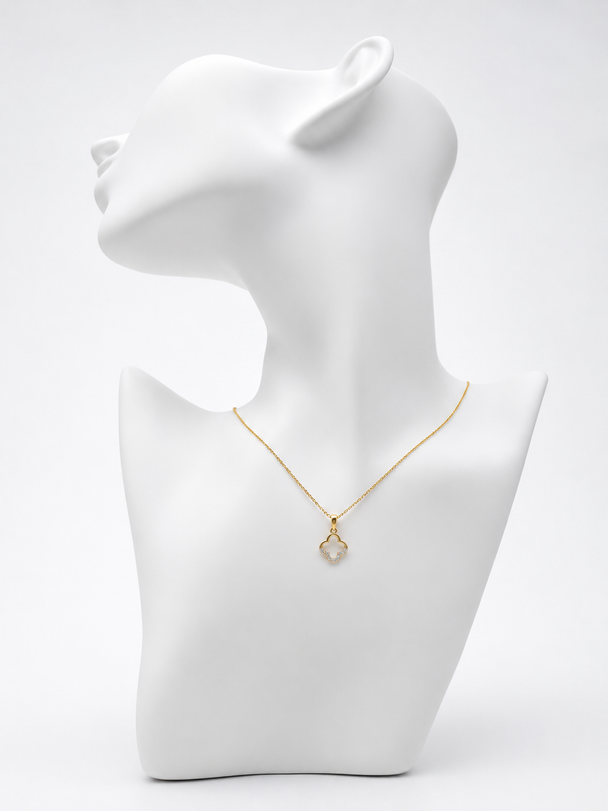 Gold necklace on a white mannequin bust against a white background