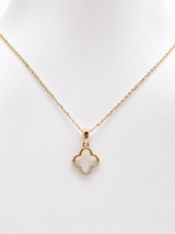 Gold necklace with a pave clover-shaped pendant on a white background